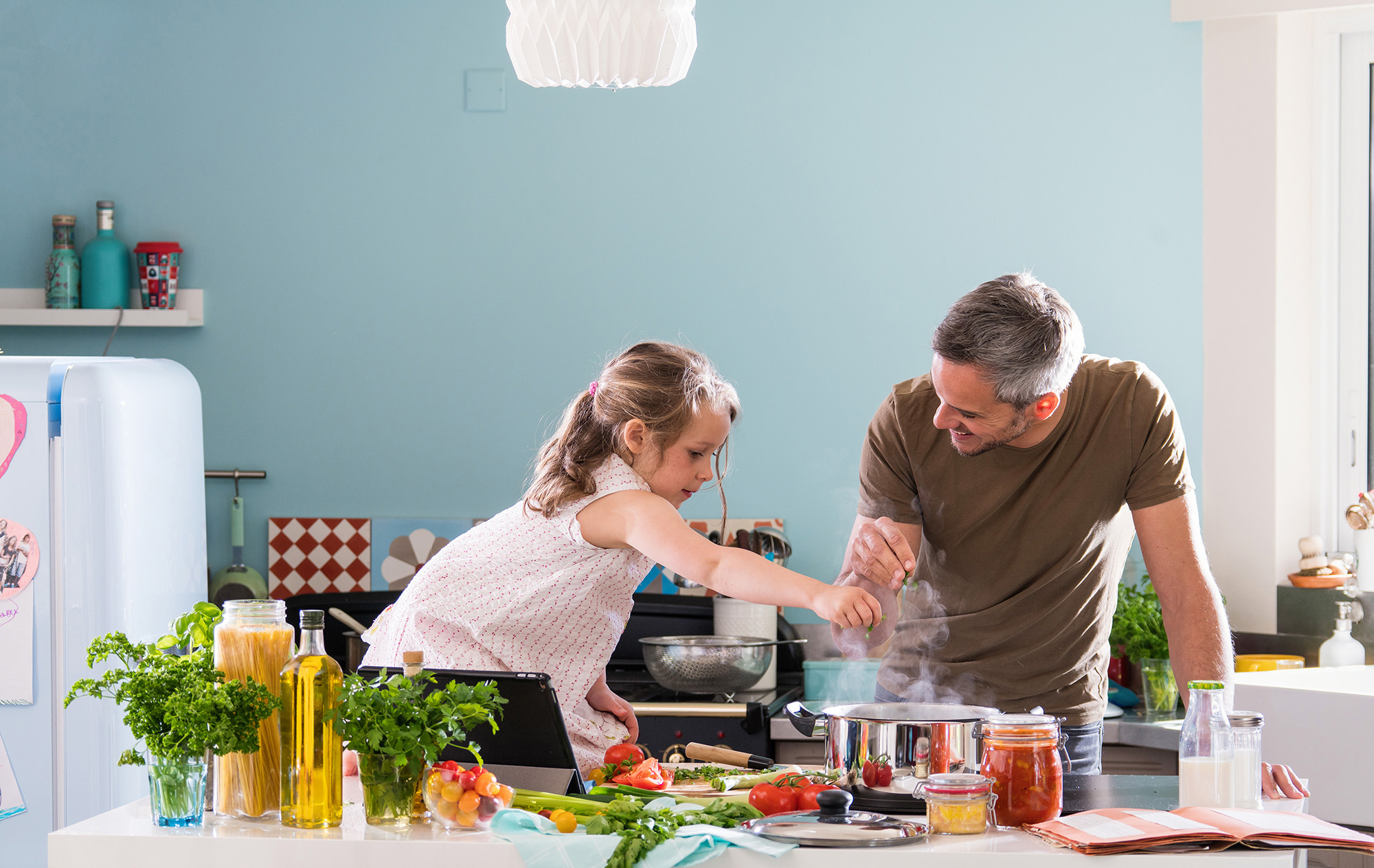 Family on Insurance cooking in the kitchen together